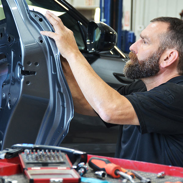 mechanic installing door